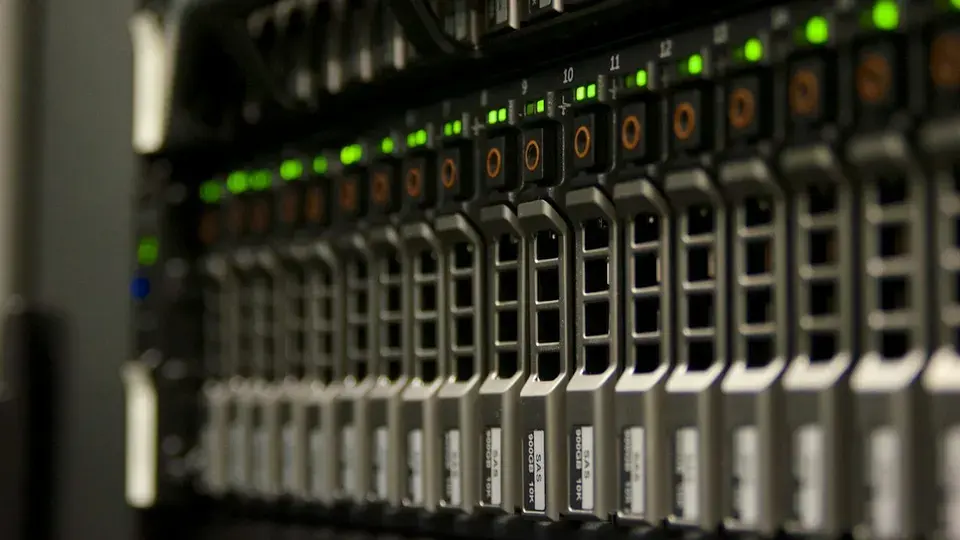 A row of rack-mounted server drive bays with green status lights